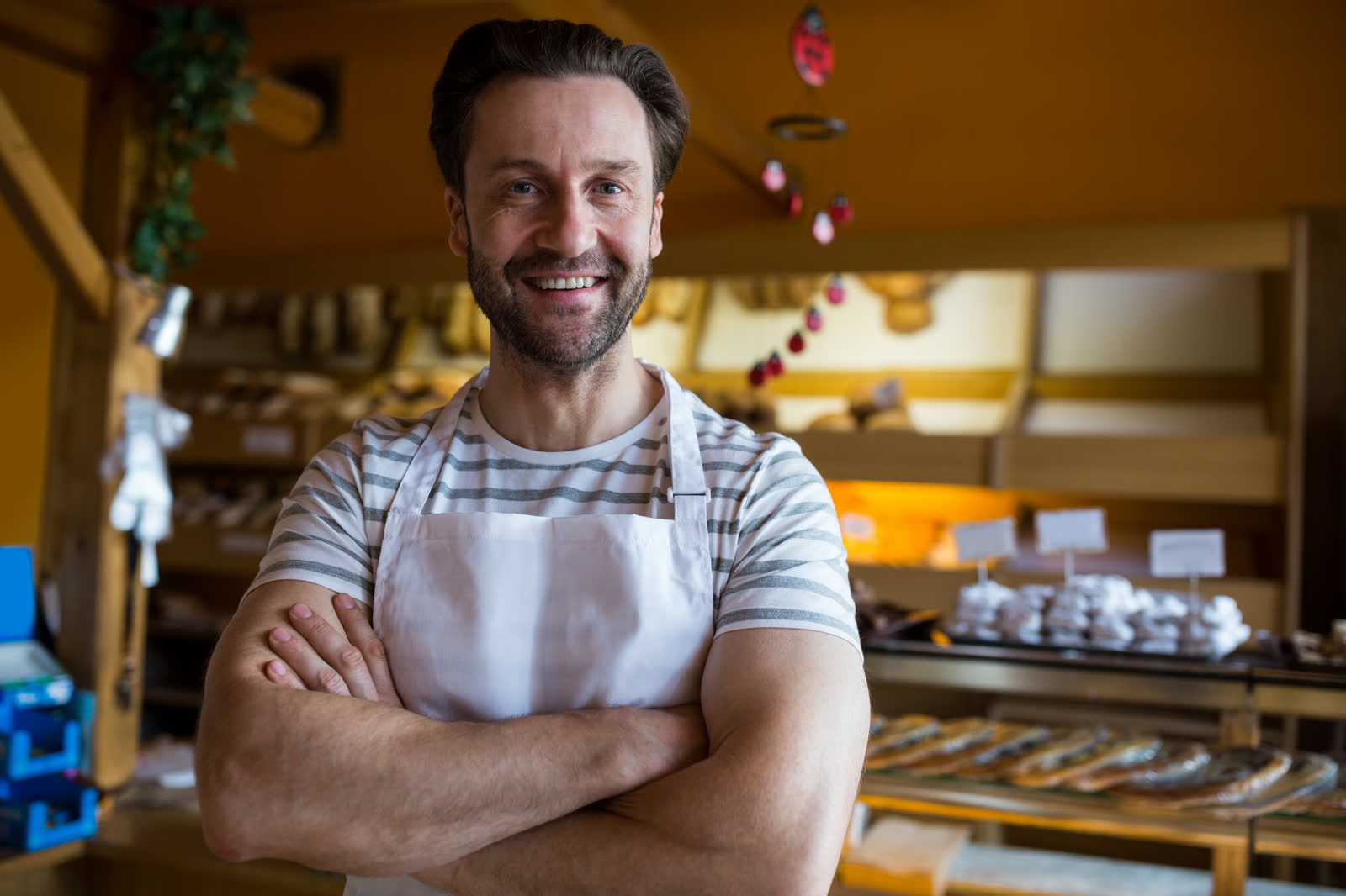 Bakery owner smiling in front of the counter